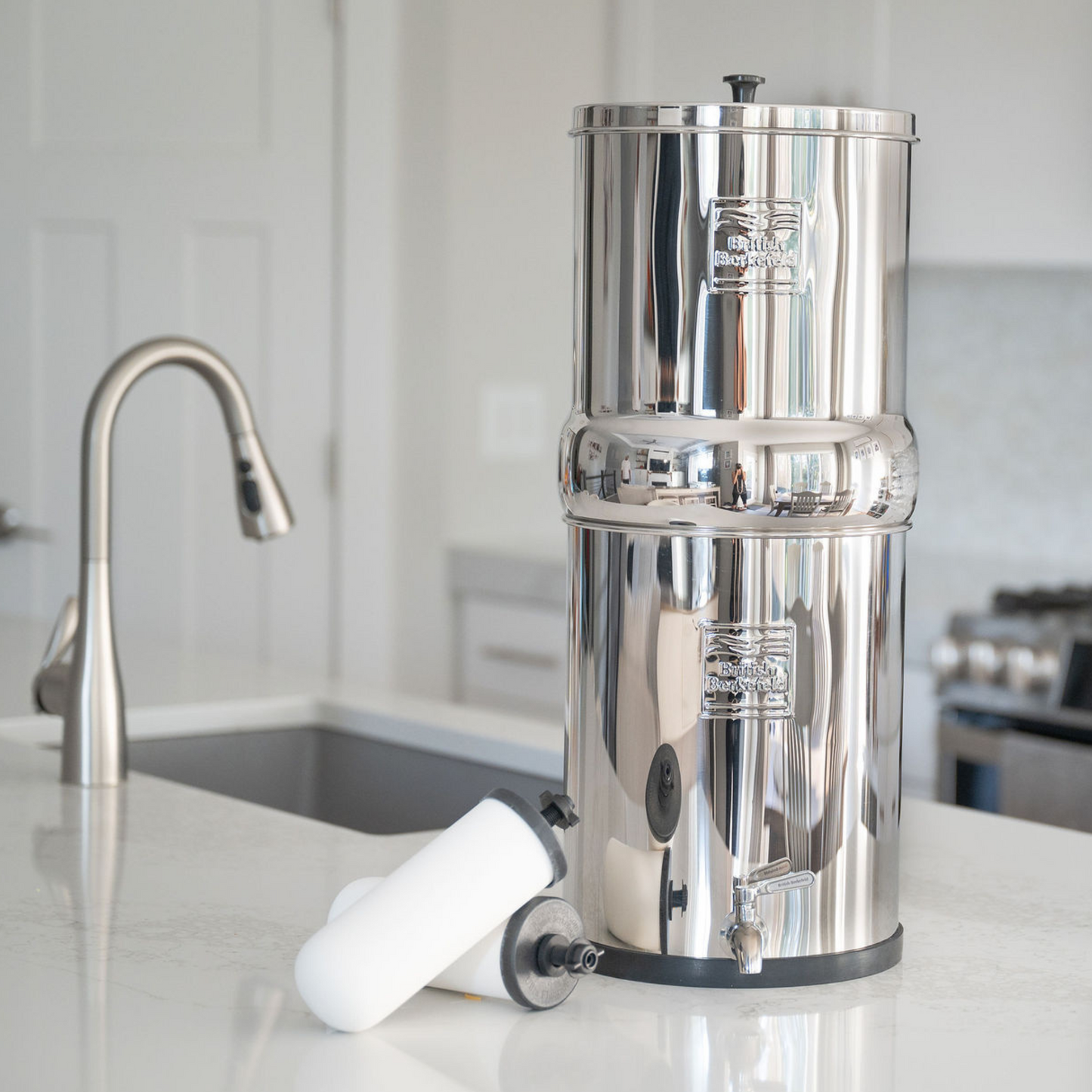 british berkefeld water filter on counter with ceramic filter elements sitting next to it
