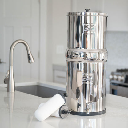 british berkefeld water filter on counter with ceramic filter elements sitting next to it